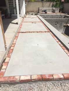 a concrete walkway being built in front of a house