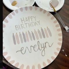 a paper plate with candles on it and the words happy birthday evelyn painted on it