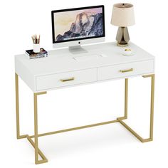 a white desk with a computer on top and a lamp next to it, in front of a white background