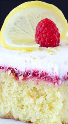 a piece of cake with raspberry and lemon on top