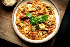 a white plate topped with pasta and shrimp