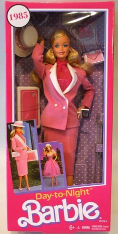 the barbie doll is wearing a pink suit and matching hat with her hair in a bunt