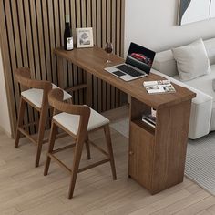 a laptop computer sitting on top of a wooden desk next to a white couch in a living room