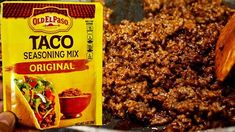 taco seasoning mix in a bowl next to a bag of chili and a wooden spoon