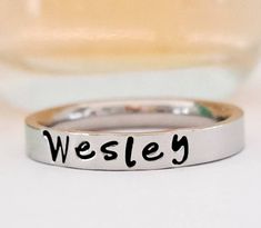 Petite name ring. Stacking name ring. Personalized name ring. This GOREOUS 3 mm ring is super shiny. Great for stacking. The surface is flat, so the lettering really stands out! Add names, initials, dates, quotes, roman numerals or scripture. I have the heart, double heart, infinity, #, &, @, !, =, *, :, ?, cross, baby foot, angel, and ribbon stamps. 15-character limit. Made of solid surgical Stainless steel which will never rust, tarnish, change color and is hypoallergenic. Swim & shower safe! Trendy Personalized Rings For Everyday, Trendy Personalized Everyday Rings, Trendy Personalized Promise Ring, Trendy Personalized Rings For Promise, Trendy Stackable Rings For Anniversary, Personalized Adjustable Stackable Rings, Trendy Personalized Adjustable Rings, Custom Name Adjustable Initial Ring For Promise, Minimalist Customizable Initial Ring For Promise