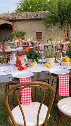 an outdoor dining area with tables and chairs covered in gingham tablecloths