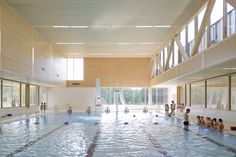 an indoor swimming pool with people in it