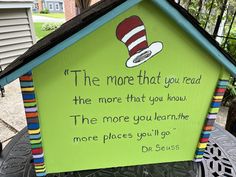 a green house with a dr seuss sign on it's side and a quote from the cat in the hat