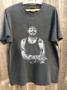 a black shirt with a drawing of a man on it