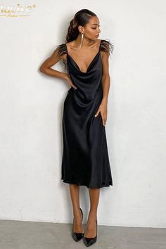 This slim midi dress features satin fabric, a sleeveless design, and a backless detail. The feather accents add a touch of elegant sophistication. Details: Silhouette: A-LINE Neckline: V-Neck Material: POLYESTER Material: SPANDEX Fabric Type: SATIN Size (IN) Bust Waist Hip Length S 33.07 26.38 36.22 48.43 M 34.65 27.95 37.80 48.82 L 36.22 29.53 39.37 49.21 Sleeveless Satin Backless Dinner Dress, Sleeveless Satin Backless Dress For Dinner, Backless Satin Midi Evening Dress, Backless Satin Evening Midi Dress, Sleeveless Satin Backless Dress With Bias Cut, Midi Length Party Slip Dress, Sleek Sleeveless Satin Dress For Dinner, Midi Party Slip Dress, Party Midi Slip Dress