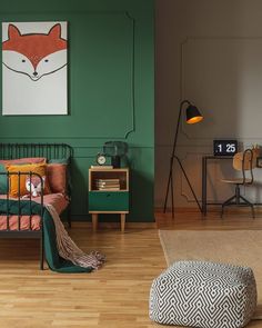 a bedroom with green walls and wood flooring is pictured in this image, the bed has an animal head on it