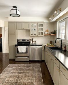 a kitchen with an area rug on the floor