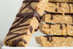 chocolate drizzled on the top of some oatmeal bars with one bite taken out