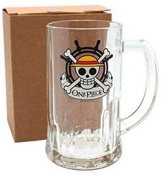 a glass mug with a skull and crossbones on it next to a cardboard box