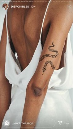 a woman with a snake tattoo on her arm