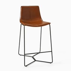 a brown leather stool with metal legs and a black frame on an isolated white background