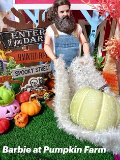 there is a fake pumpkin with a man in overalls next to the fake pumpkin