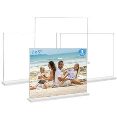 three clear acrylic frames with an image of family sitting on the beach in front of them