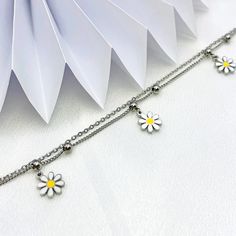 Embrace the girly charm of our Daisy Charms Bracelet and let it be your go-to accessory for every occasion. Whether worn alone or layered with other bracelets, it's sure to become a cherished favorite in your jewelry collection. Available in silver and gold. Trendy Hypoallergenic Charm Bracelet For Friendship, Adjustable Bracelets With Dangling Charms For Friendship, Trendy Adjustable Bracelets With Dangling Charms, Trendy Adjustable Chain Bracelet With Charms, Dainty Adjustable Dangle Charm Bracelet, Trendy Silver Hypoallergenic Friendship Bracelets, Trendy Hypoallergenic Silver Friendship Bracelets, Adjustable Charm Bracelet With Dangling Charms For Friendship, Trendy Adjustable Chain Charm Bracelet For Friendship