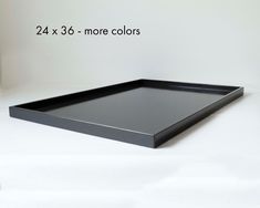 a large black tray sitting on top of a white table