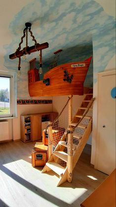 there is a room with a boat painted on the wall and stairs leading up to it