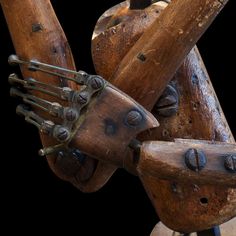 a wooden sculpture with many pieces of wood on it's arms and legs,