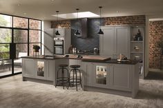 a large kitchen with an island and bar stools