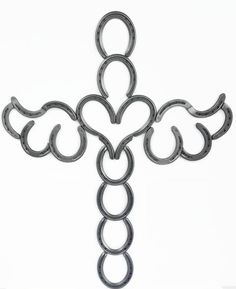 a cross made out of metal rings on a white background