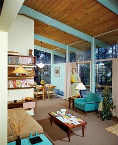 a living room filled with furniture and lots of windows