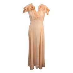 Elegant Peach Silk Chiffon Art Deco Pleated Edge Trimmed Gown from the 1930's. Pleated trim is used to edge the cape collar, sleeves and create neckline flowers. Hook and eye closure at neck with pleated detail down front. Full bias skirt. Gown is sheer. 1930's USA. Small size 2-4. Bust 32", Waist 26", Hip 36". 1stdibs Dress, Vintage Silk Chiffon Summer Dress, Luxury Vintage Silk Chiffon Dresses, Vintage Silk Dress With Beading, Vintage Silk Flapper Dress, Vintage Silk Beaded Dress, Silk Gown, Silk Chiffon, Vintage Dresses