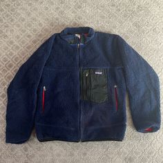 Warm And Wind Proof Vintage Patagonia Full-Zip Fleece. Men’s M. Small Signs Of Wear But Still Has A Full Life Ahead Of It. Navy Exterior And Red Interior Fleece Jacket Outfit Men, Fleece Jacket Outfit, Navy Exterior, Patagonia Retro X, Lizzy Mcalpine, Fleece Men, Outfit References, Holiday Wishlist, Coats Vintage