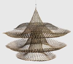 an abstract, brown, suspended sculpture with three splayed layers, made from crocheted wire by Ruth Asawa