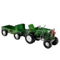 a green toy truck with christmas decorations on it's side and wheels that are attached to the front