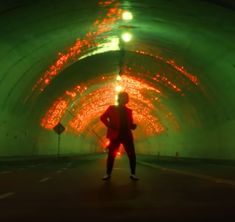 a man standing in the middle of a tunnel