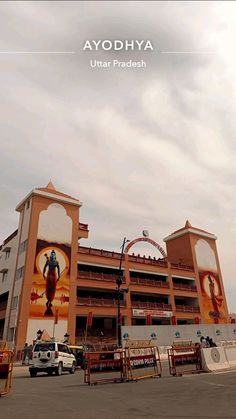 a large building with an advertisement on it's side in the middle of a parking lot