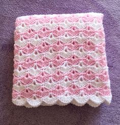 a pink and white crocheted dish cloth