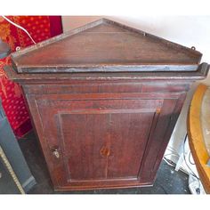 an old wooden cabinet sitting on top of a floor