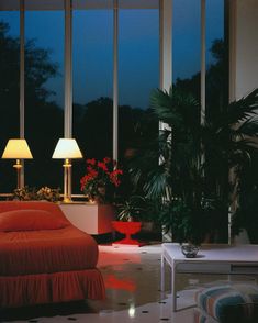 a living room filled with furniture and large windows