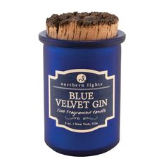 a blue jar with a cork top and label on the lid that says blue velvet gin