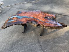 a large piece of wood sitting on top of a sidewalk