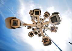 an upside down view of a street light with multiple cameras on it's sides