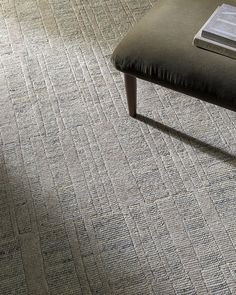 a bench sitting on top of a carpet covered floor