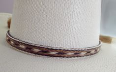 Cowboy hat band, genuine horsehair hat band, Five Strands wide ( 5/8 inch) BOLDLY done in a a natural brown-rich black and off-white Double horse hair tassels, Oh So Stetson perfect, **VERY Distinctive look **OUTSTANDING QUALITY ** STETSON perfect ** LUXURIOUS 100% genuine horsehair ** 5/8 inch wide. You will quickly discover that nothing compares to this extraordinary beauty: This horsehair hat band DEMANDS attention. This beauty is a 5 strands wide. Each strand is about 1/8 inch wide, separate White Short Brim Panama Hat For Ranch, Classic White Hat Bands For Rodeo, Classic White Hat Band For Rodeo, Classic White Panama Hat For Ranch, White Brimmed Hat Bands For Rodeo, White Adjustable Panama Hat For Western-themed Events, White Fedora Panama Hat For Ranch, White Southwestern Short Brim Hat, Adjustable White Fedora Hat Bands