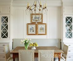 a dining room table with four chairs and a chandelier hanging from the ceiling