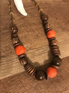 A very cool, handmade necklace for women, choker, made of wood, ceramic and different materials. African - inspired, tribal, pop of color, earthy. Features: - 19 inches long; - brown, with orange accents; - African - inspired, cool look; - closure type: lobster claw. Thank you for visiting my shop. Cheap Traditional Wooden Beaded Necklaces, Unique Brown Wooden Bead Jewelry, Unique Brown Necklaces With Colorful Beads, Earthy Brown Necklace With Large Beads, Unique Orange Necklace With Wooden Beads, Adjustable Brown Wooden Necklaces, Bohemian Wooden Bead Choker Necklace, Earthy Brown Beaded Necklaces For Festivals, Bohemian Brown Wooden Beaded Necklaces