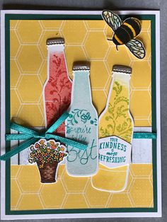 a card with two beer bottles and a bee