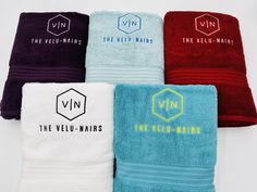 five towels with different colors and logos on them