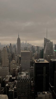 an aerial view of the city skyline with tall buildings and skyscrapers in the foreground