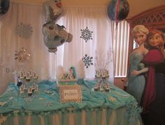 a frozen princess themed birthday party with balloons and decorations on the table in front of it