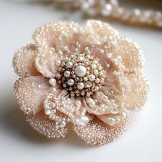 a white flower with pearls on it